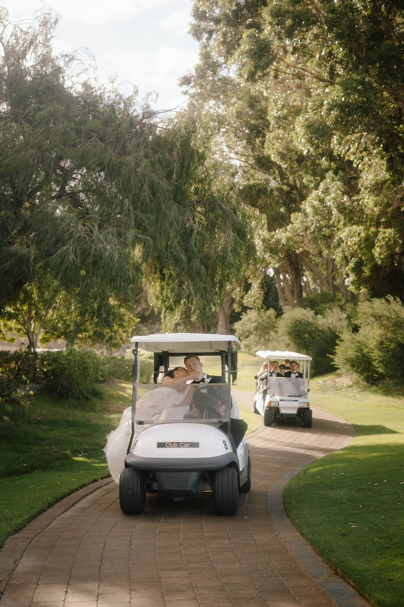 bride-groom-kissing-wedding-photographer-golf-cart.jpg