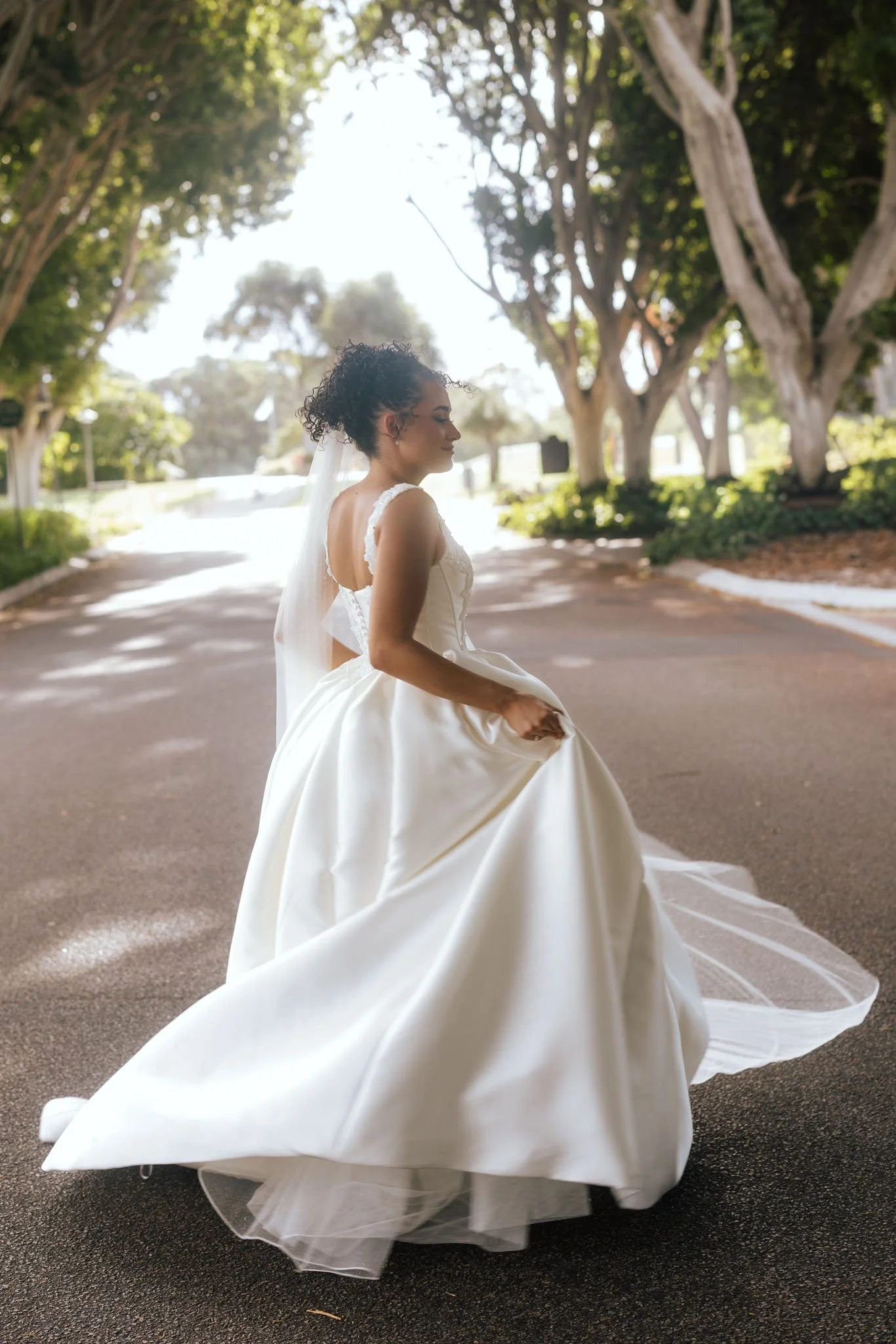 bride-twirling-wedding-dress-photographer-videographer.jpg