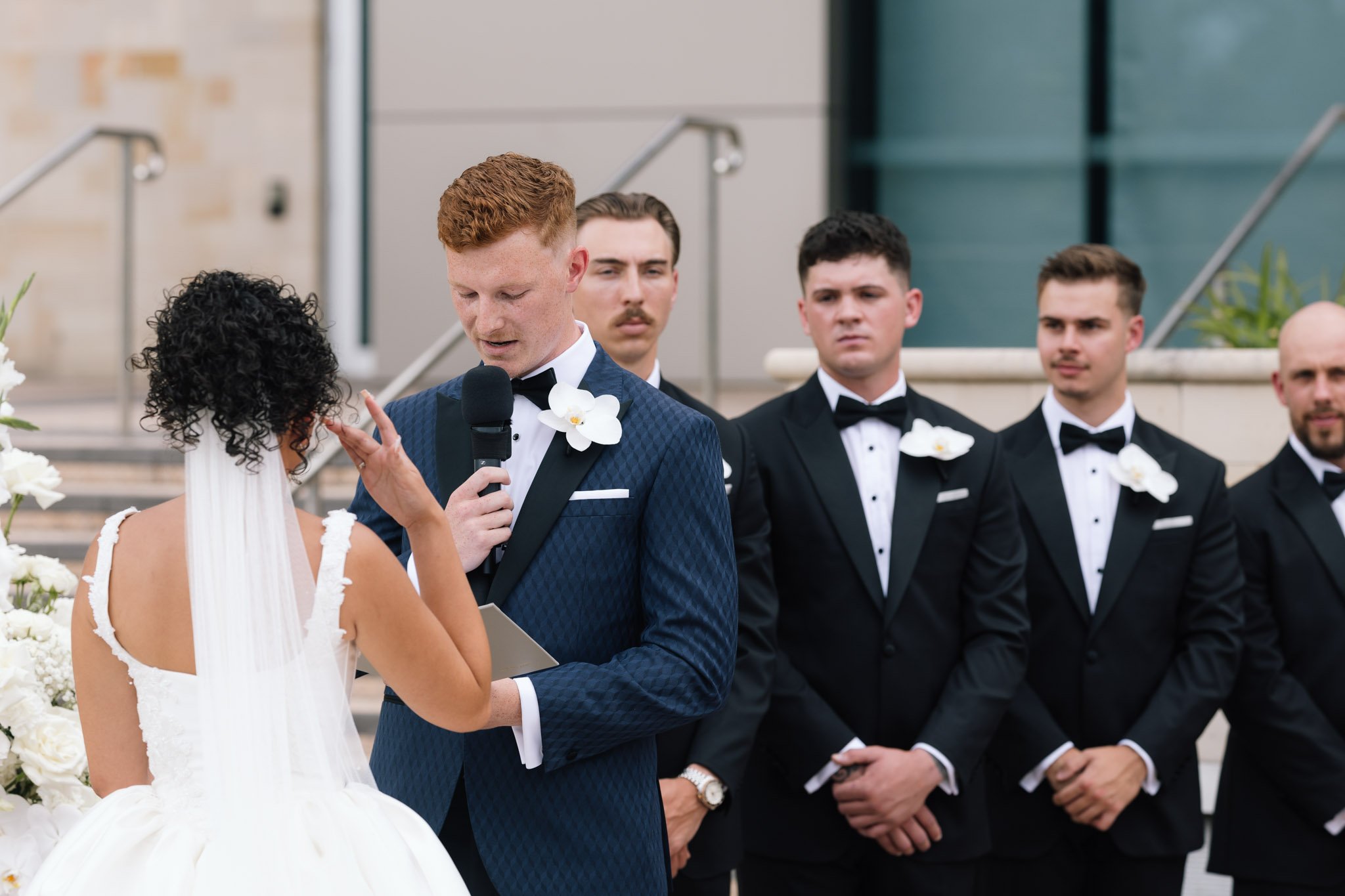 groom-reading-vows-wedding-photographer-videographer.jpg