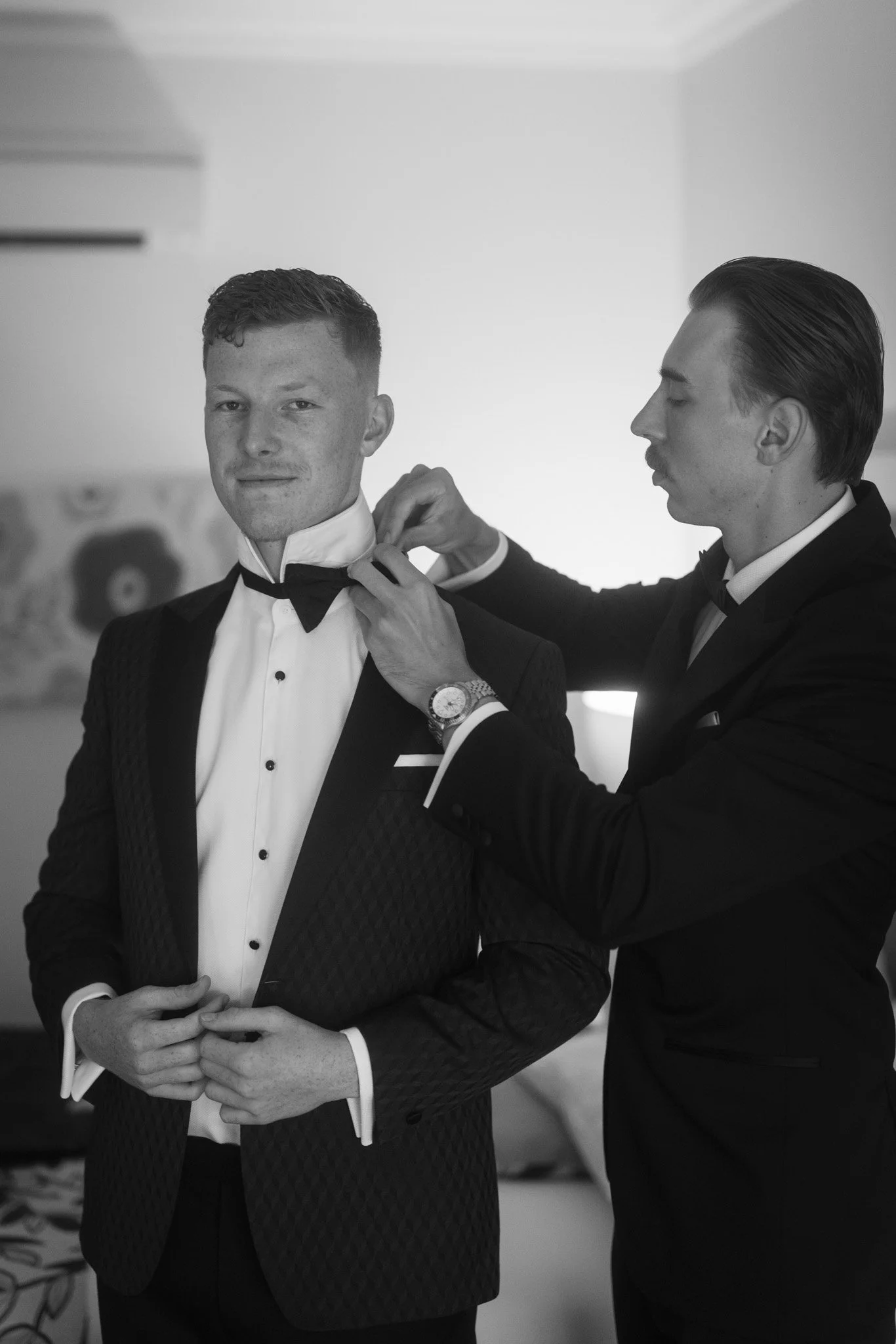 groomsman-adjusting-tie-wedding-photographer.jpg