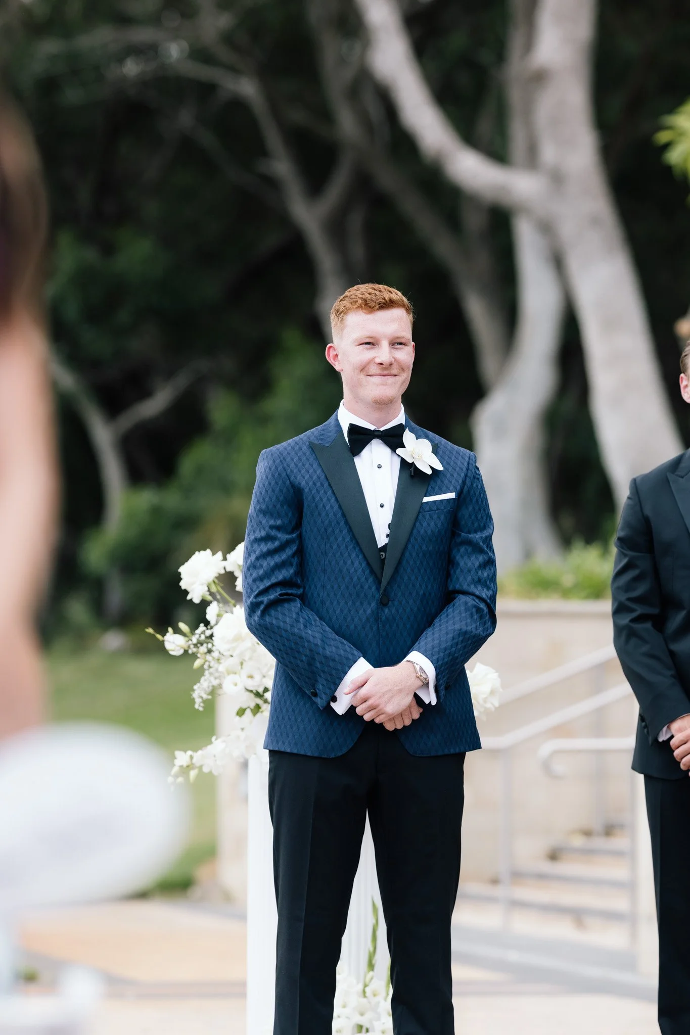 groom-smiling-at-wedding-photographer-videographer.jpg