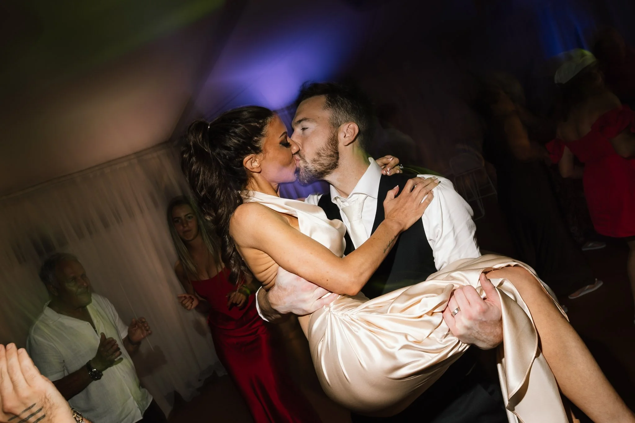 Groom lifting and kissing the bride during a joyful dance floor moment at their Swan Valley wedding reception at The Mallard Duck Perth, captured by James Di Stefano