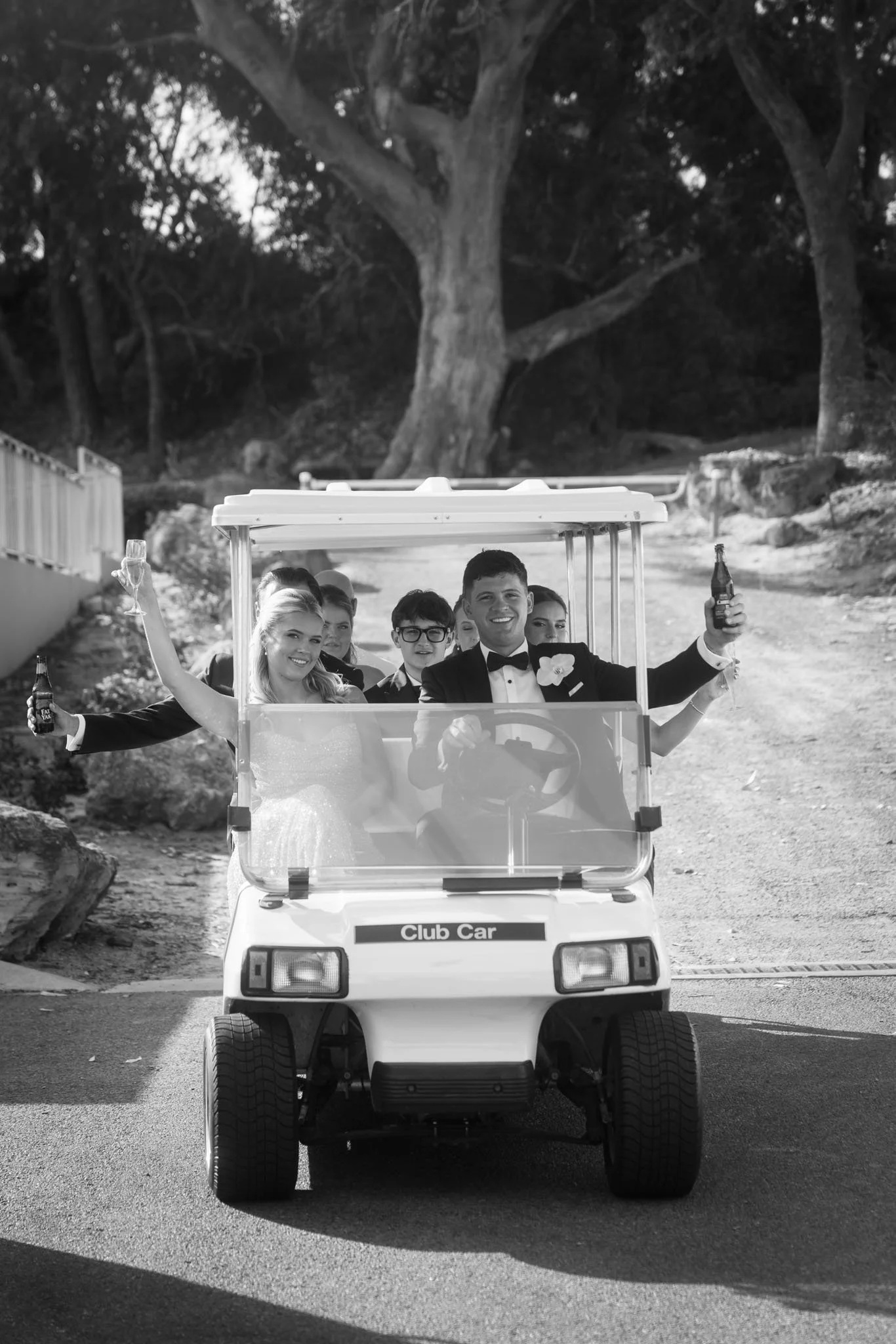 wedding-party-riding-golf-cart-photographer.jpg