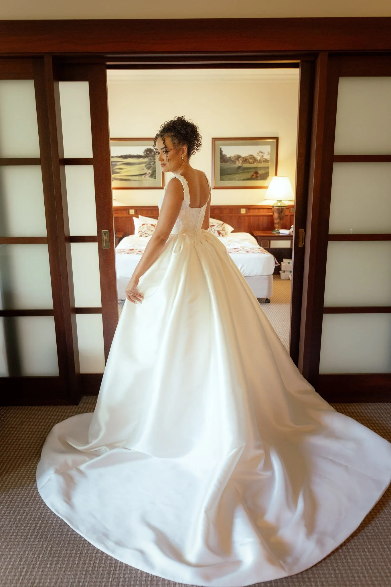 bride-in-wedding-dress-standing-in-doorway-photographer.jpg