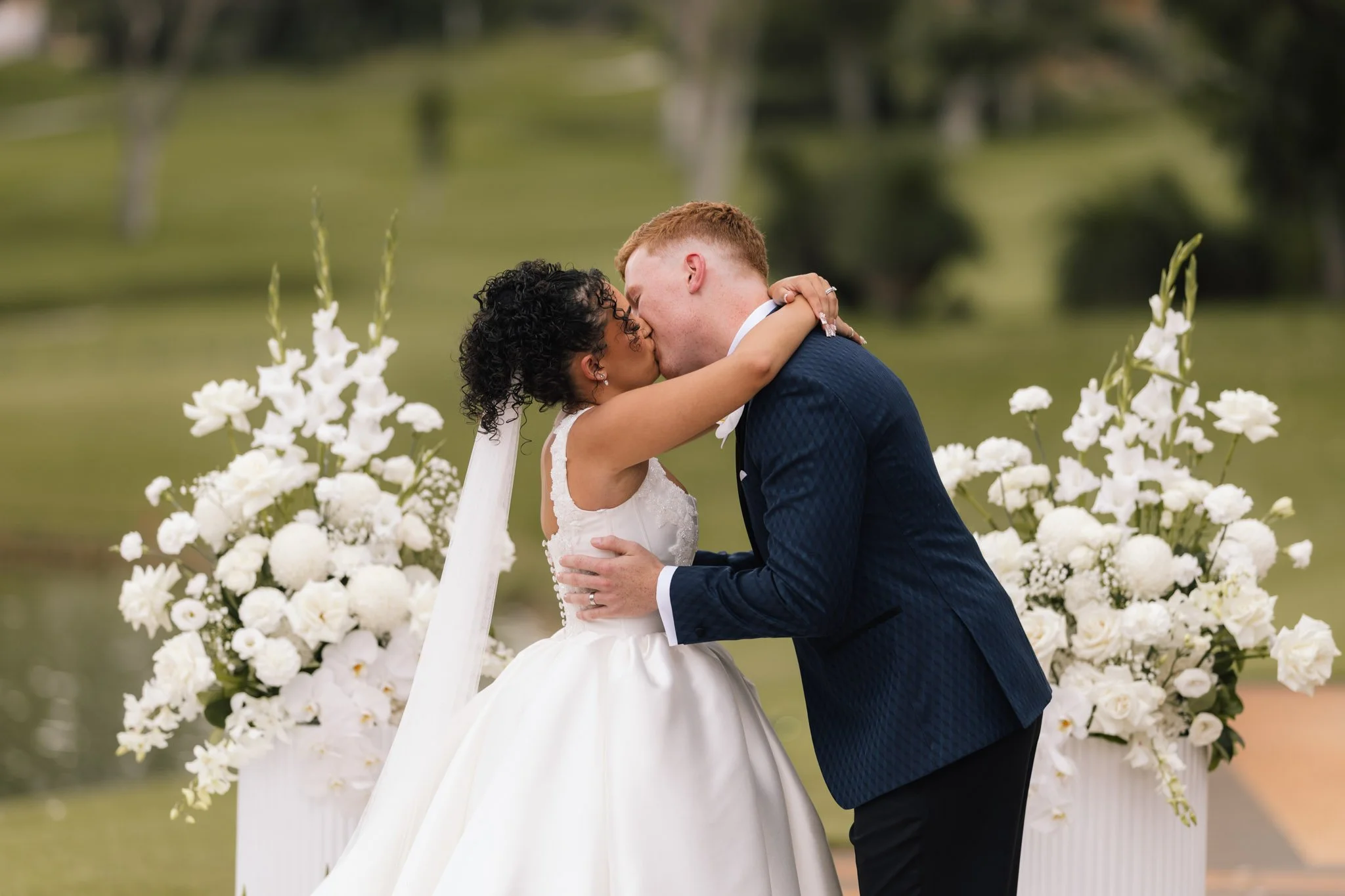 bride-groom-kissing-outdoor-wedding-photographer.jpg