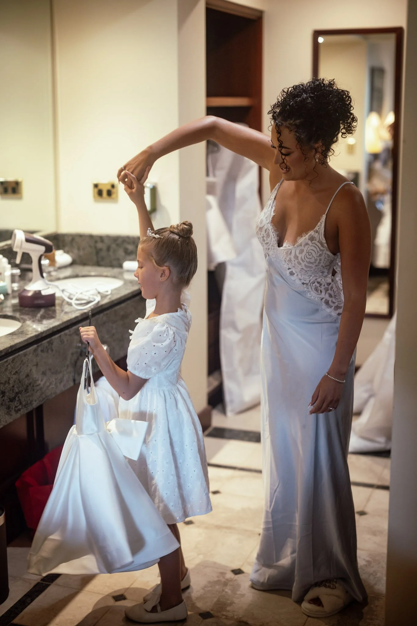 bride-and-flower-girl-getting-ready-wedding-photographer.jpg