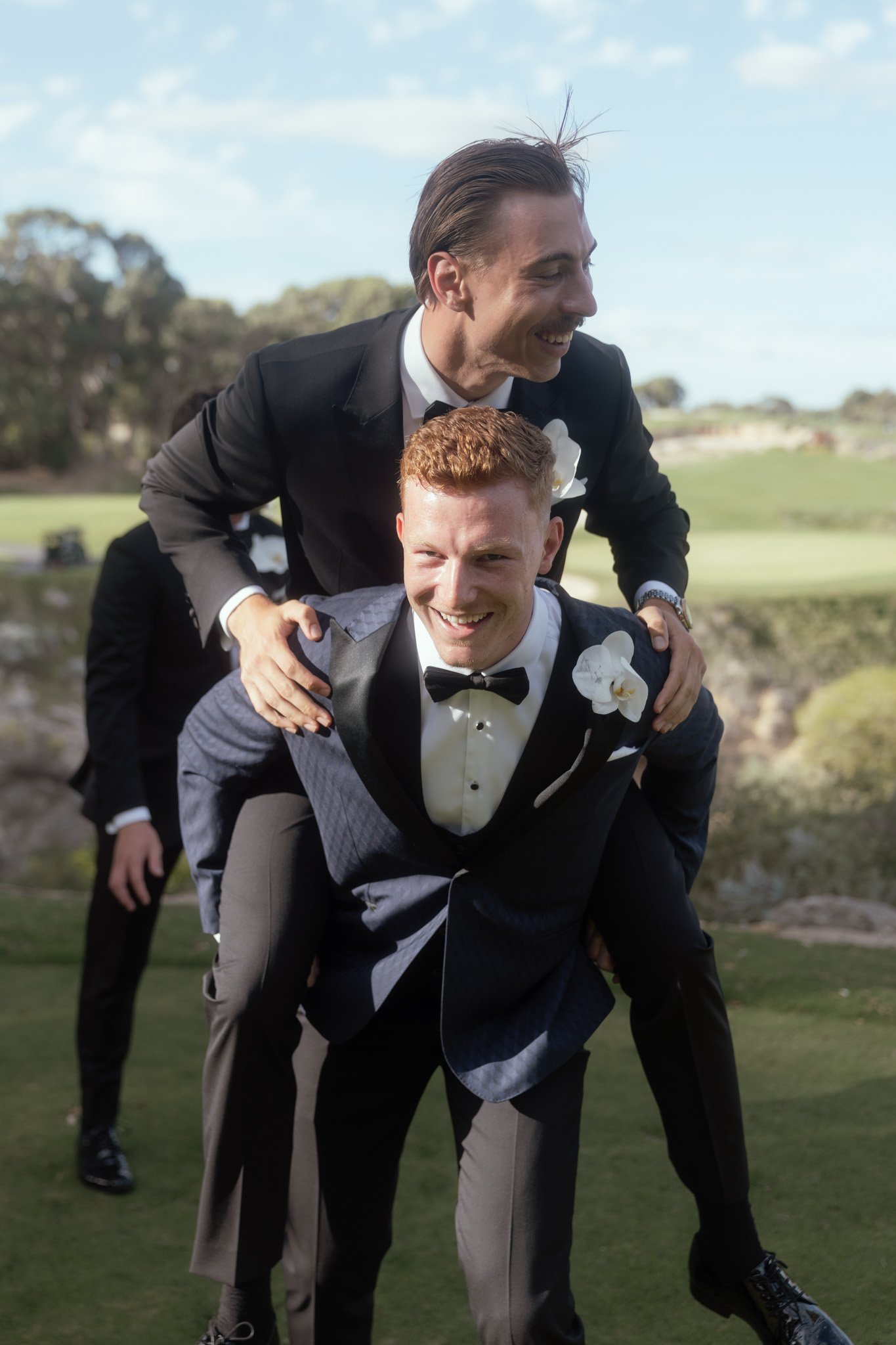 groomsmen-piggyback-ride-wedding-photographer.jpg