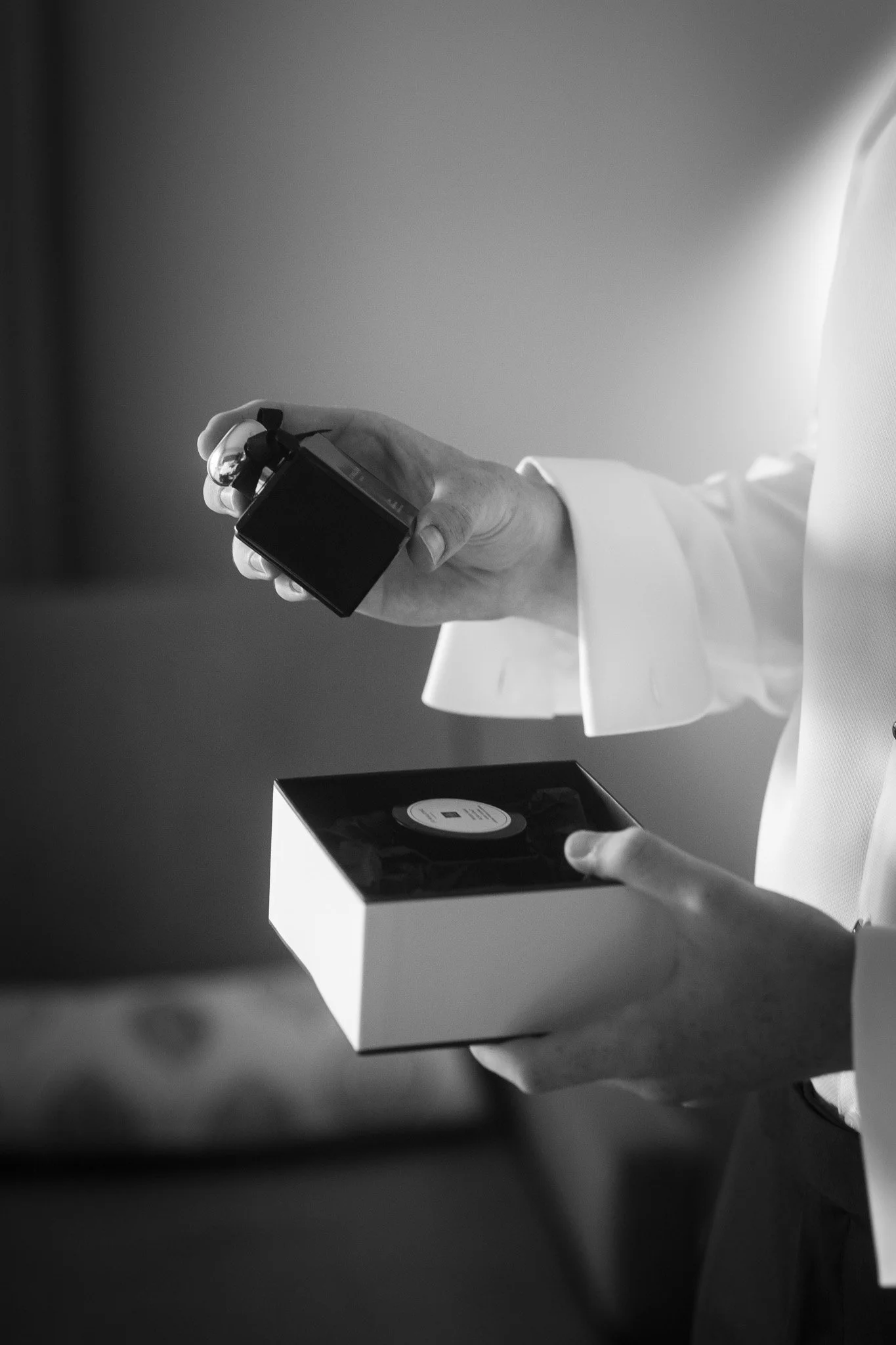 groom-holding-perfume-wedding-photographer.jpg