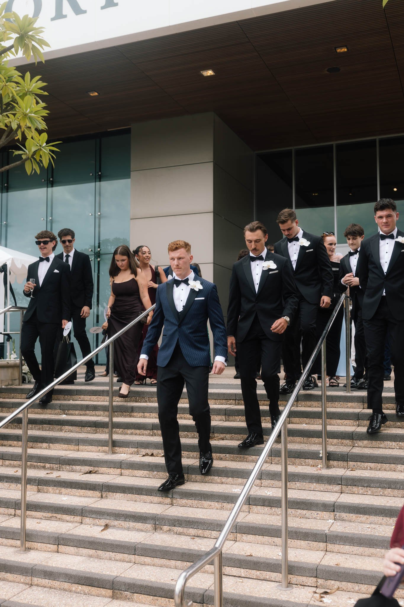 wedding-party-walking-down-stairs-photographer.jpg