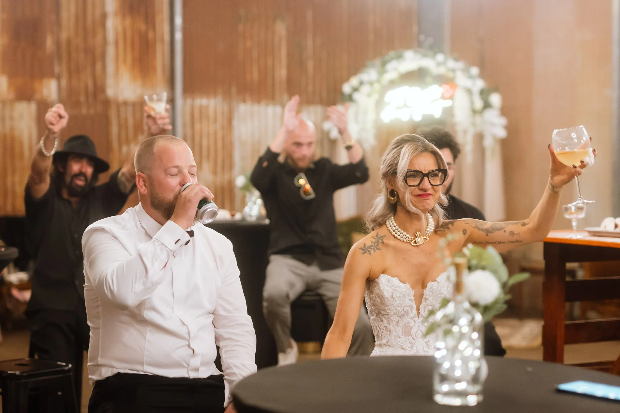 An emotional close-up of the bride crying happy tears and raising a wine glass alongside her groom during the reception speeches at a luxury Buckland Estate wedding