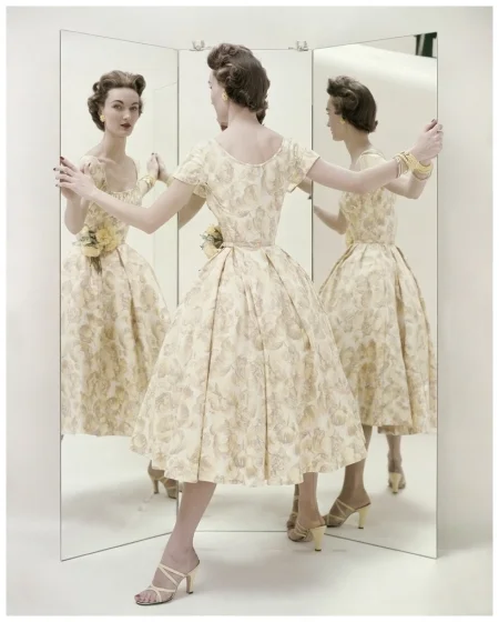 model-standing-in-front-of-three-way-mirror-wearing-a-pale-yellow-summer-party-dress-by-kane-with-matching-mules-by-valley-photo-richard-rutledge-april-1954-22three-views-of-a-summer.jpg