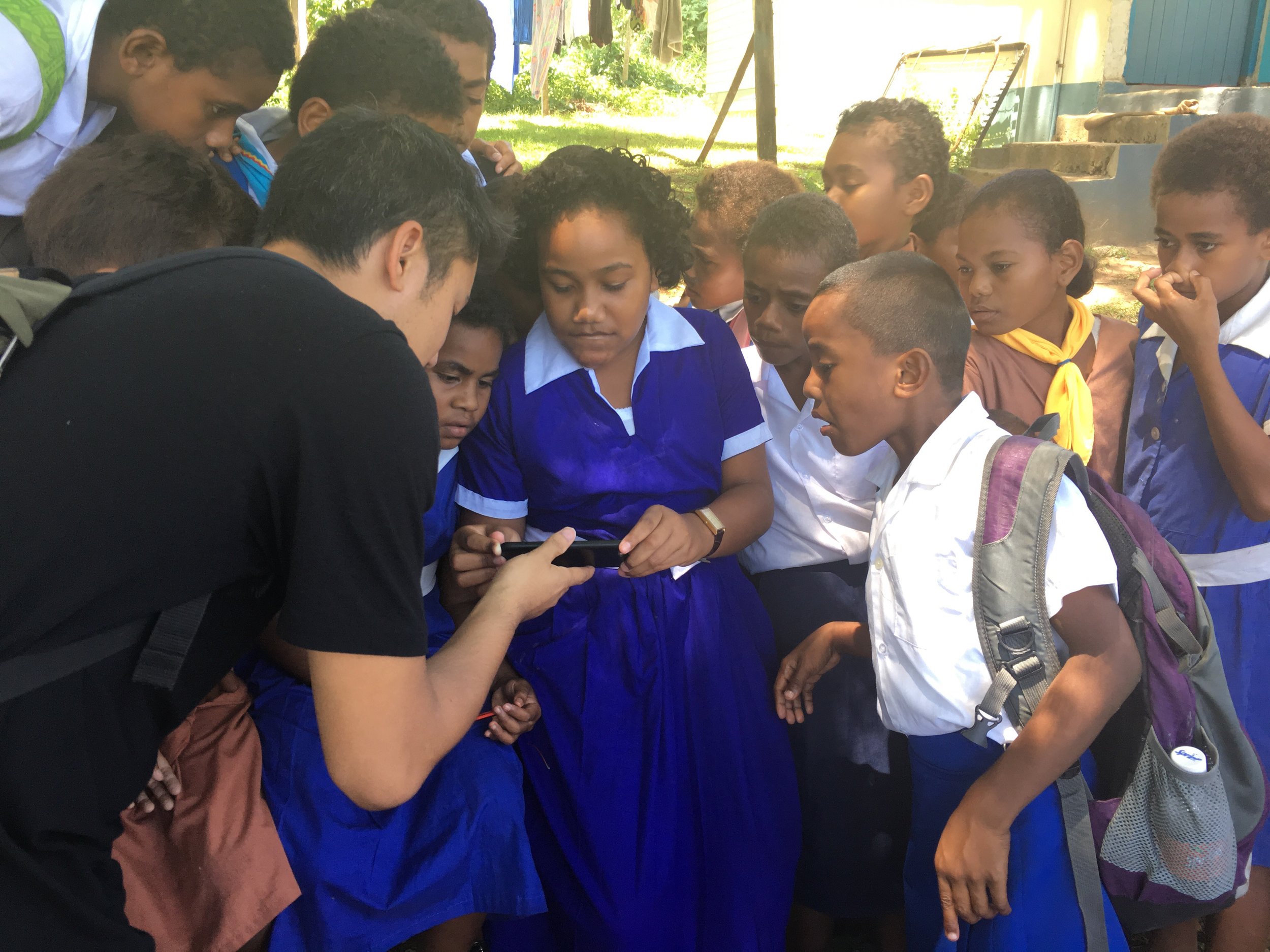Producer Tash Tan of S1T2 sharing an AR demo to school students on a LAUNCH Legends field reporting trip to Fiji photo by Rob Oliver 
