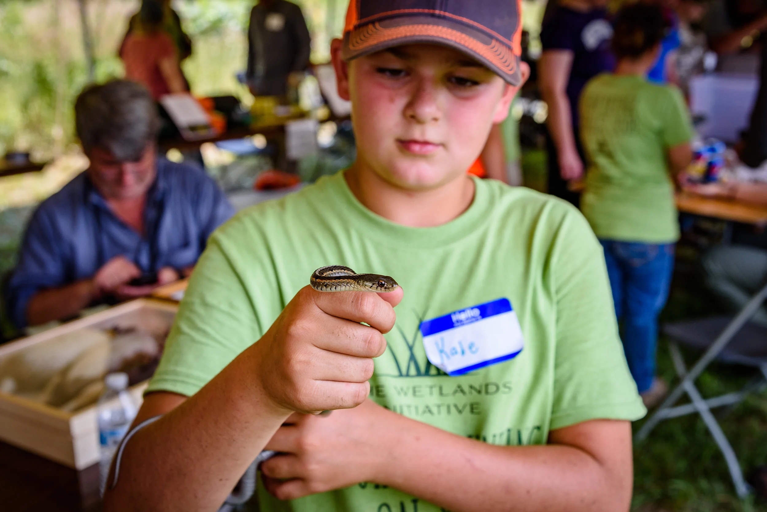A young BioBlitz participant gets friendly with a garter snake. Photo by Rafi Wilkinson.