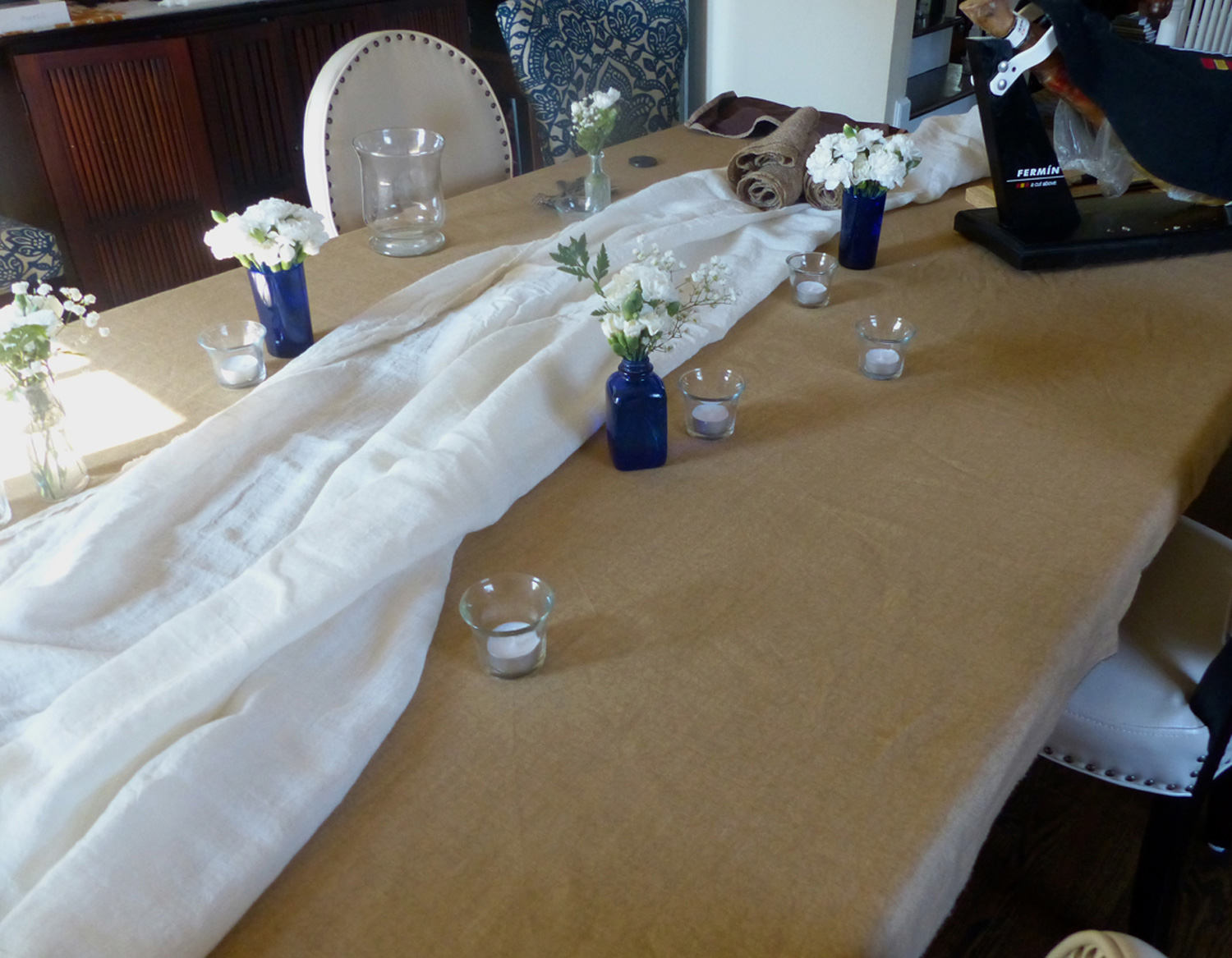 Starting to lay out the table scape using fabric pieces from a garage sale
