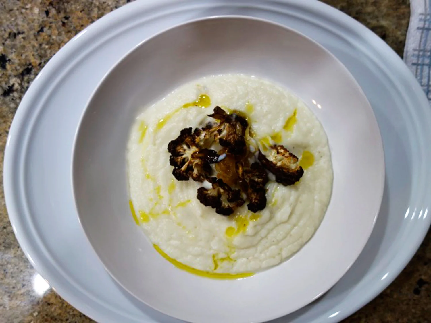Cauliflower soup with crispy cauliflower florets and drizzle of olive oil