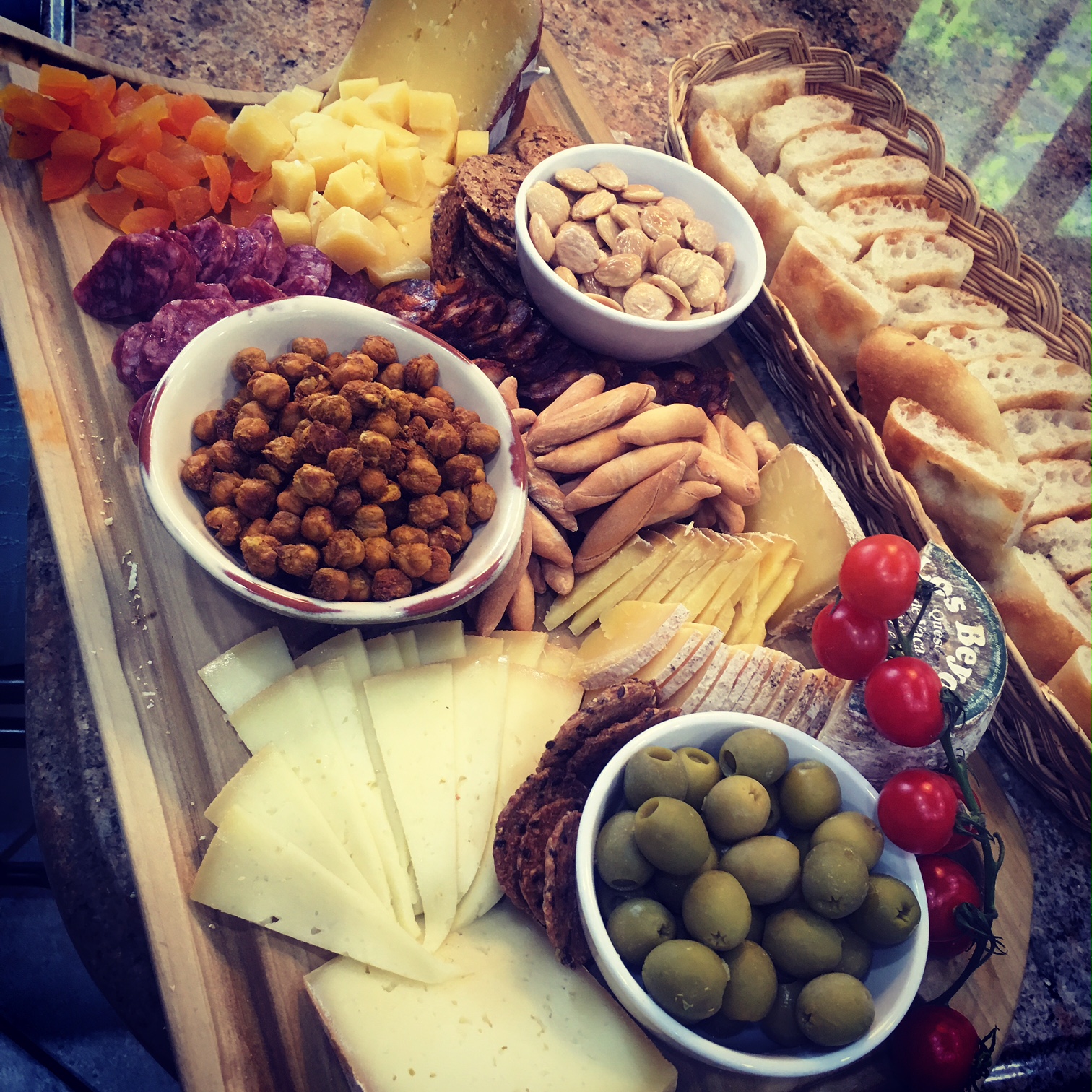 Abundant charcuterie platter with cheeses, dry cured meats, Marcona almonds, dried apricots and of course, Spicy Chick Peas.
