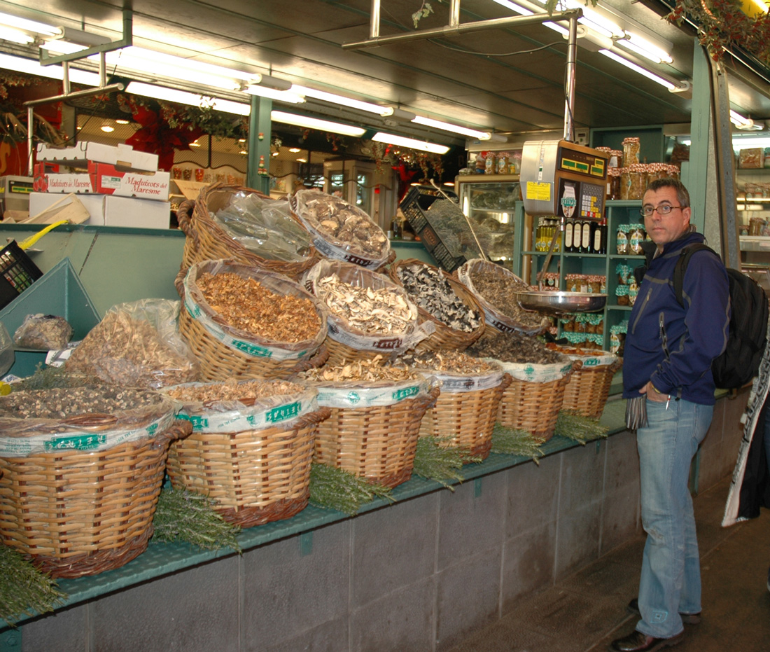 JuanCarlos in his glory in front of a large variety of dried mushrooms in Barcelona.