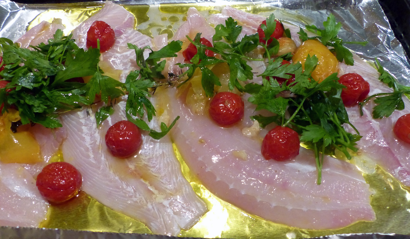 On an aluminum lined baking sheet, place the fillets, drizzle with oil, sprinkle with salt/pepper and top with tomatoes, parsley, garlic and onion. 