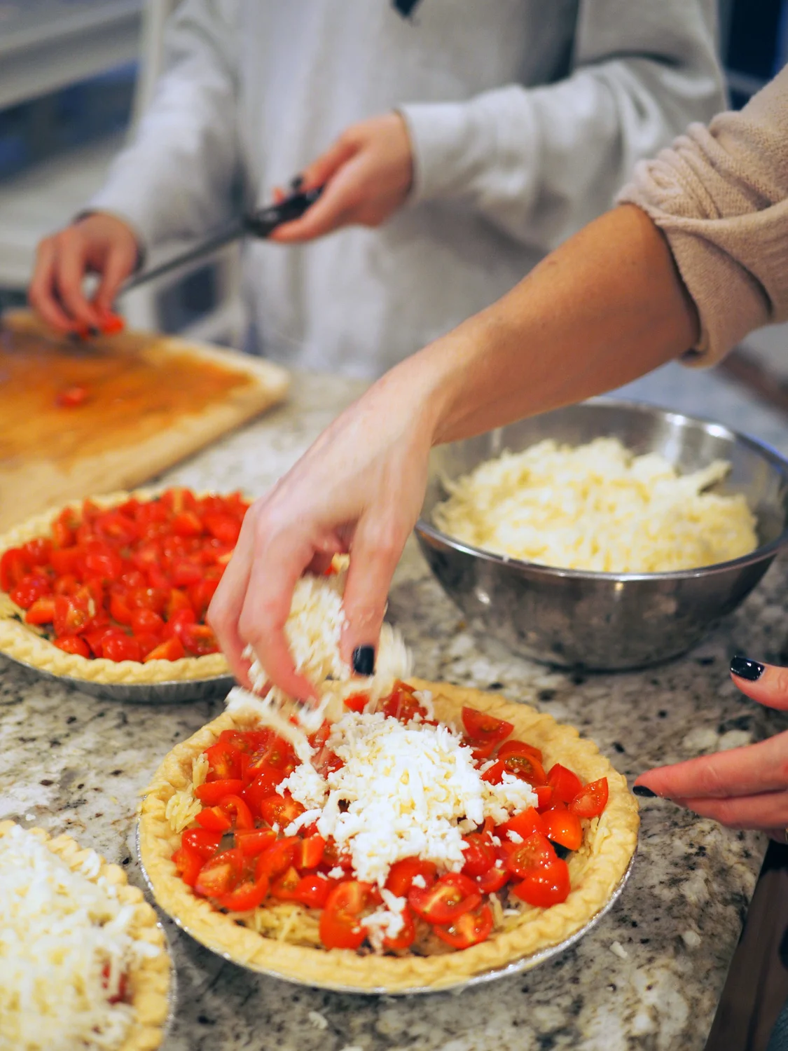 Top each pie with tomatoes and cheese.
