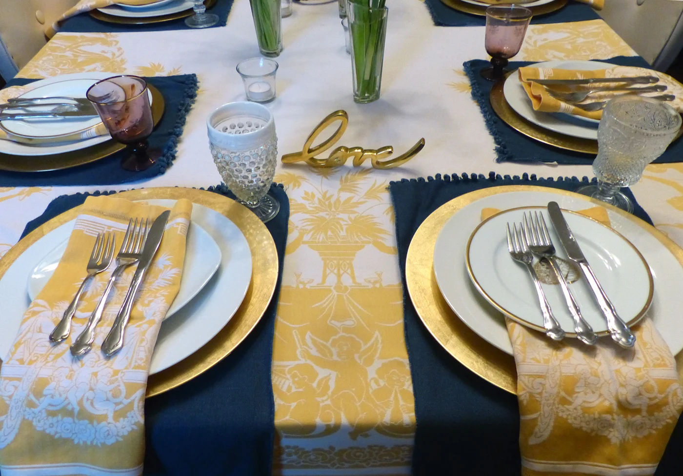 One place setting with napkin on top, the other goes under the salad plate. If you notice, I have two types of salad plates. I used the under method on the ones with the gold rim and leaf design. Why not show a pretty plate?
