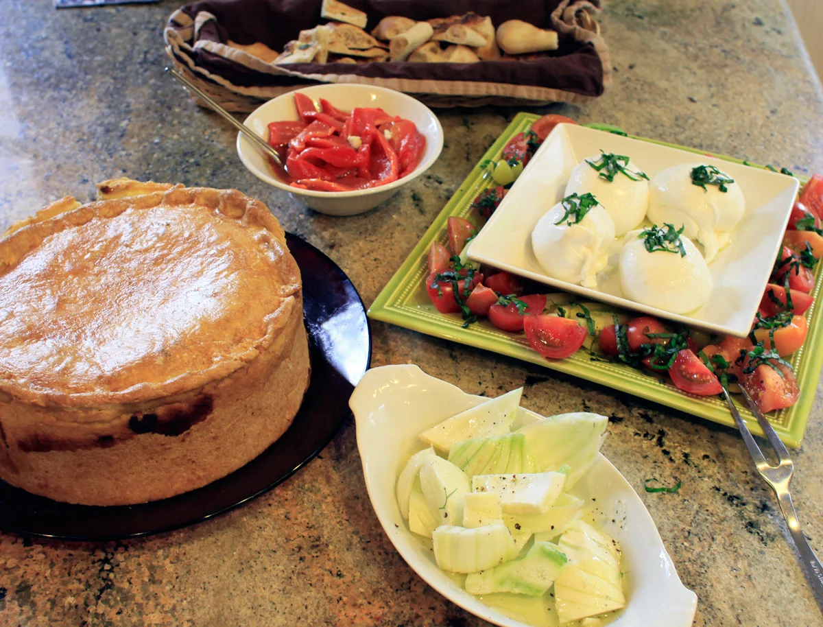 Our line up of apps one year. Roasted red peppers, burrata with fresh tomatoes/basil, fennel with coarse salt/pepper/oil and the of course, the towering Pizza Rustica.
