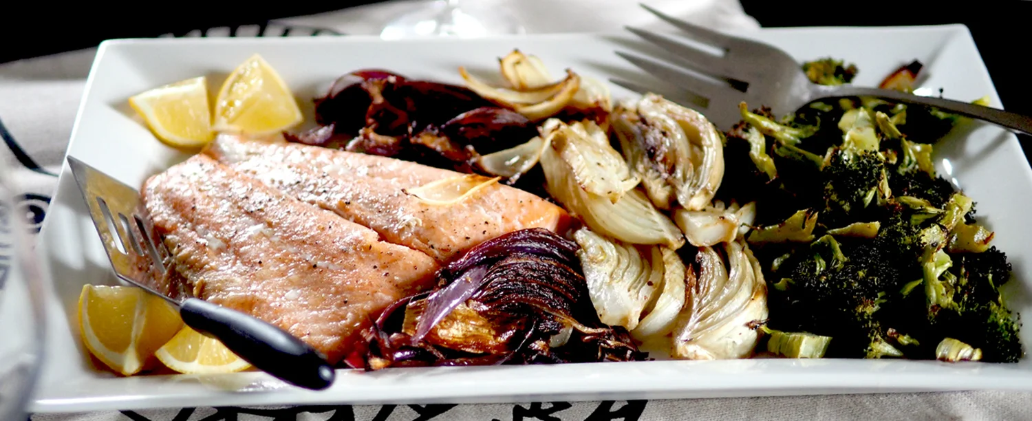 Simply roasted salmon nestled up against beautiful roasted vegetables all on one plate.