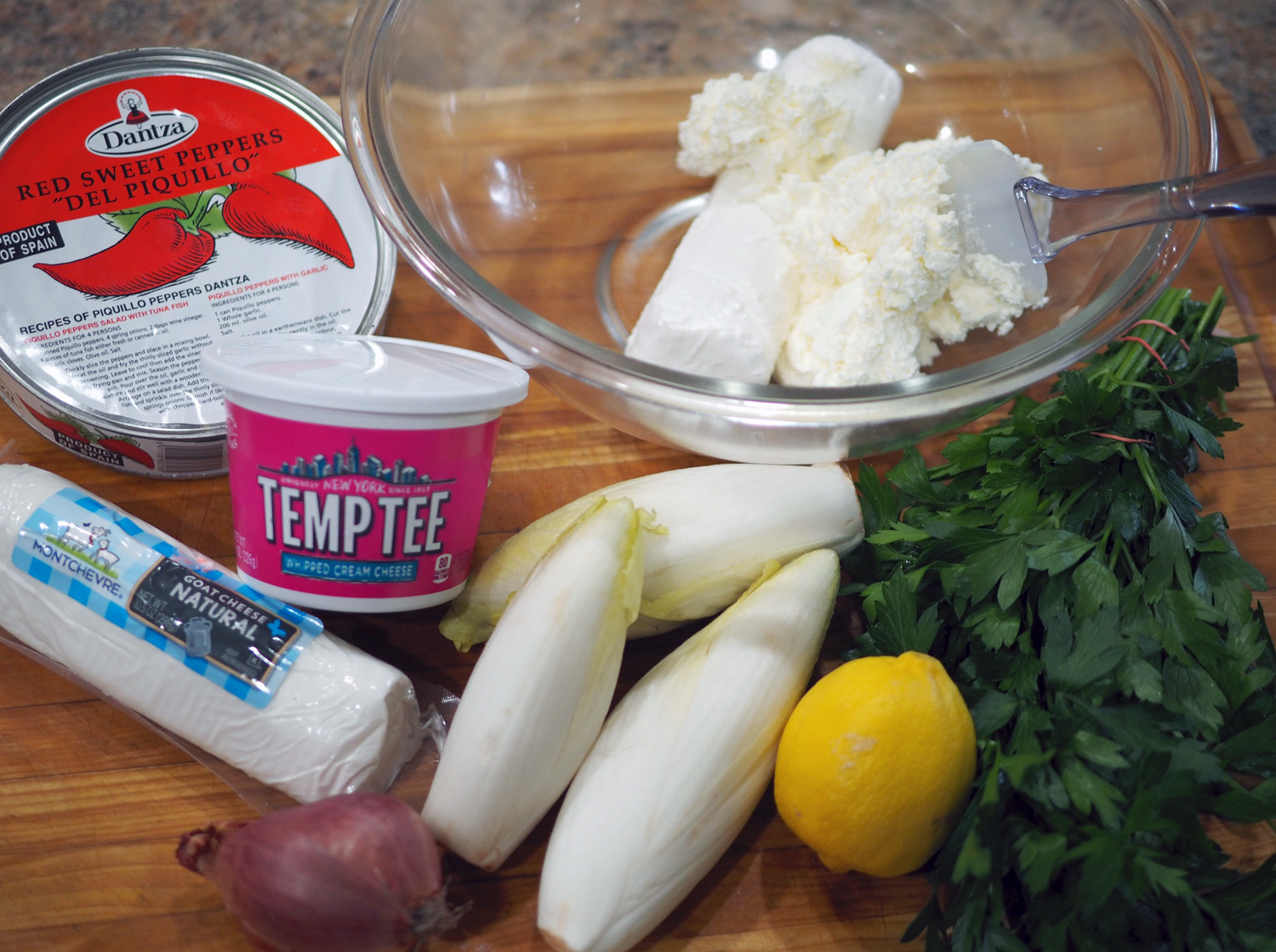 Goat cheese, whipped cream cheese, parsley, lemon, shallot, and of course, the star, piquillo peppers. I buy mine from Despaña . 