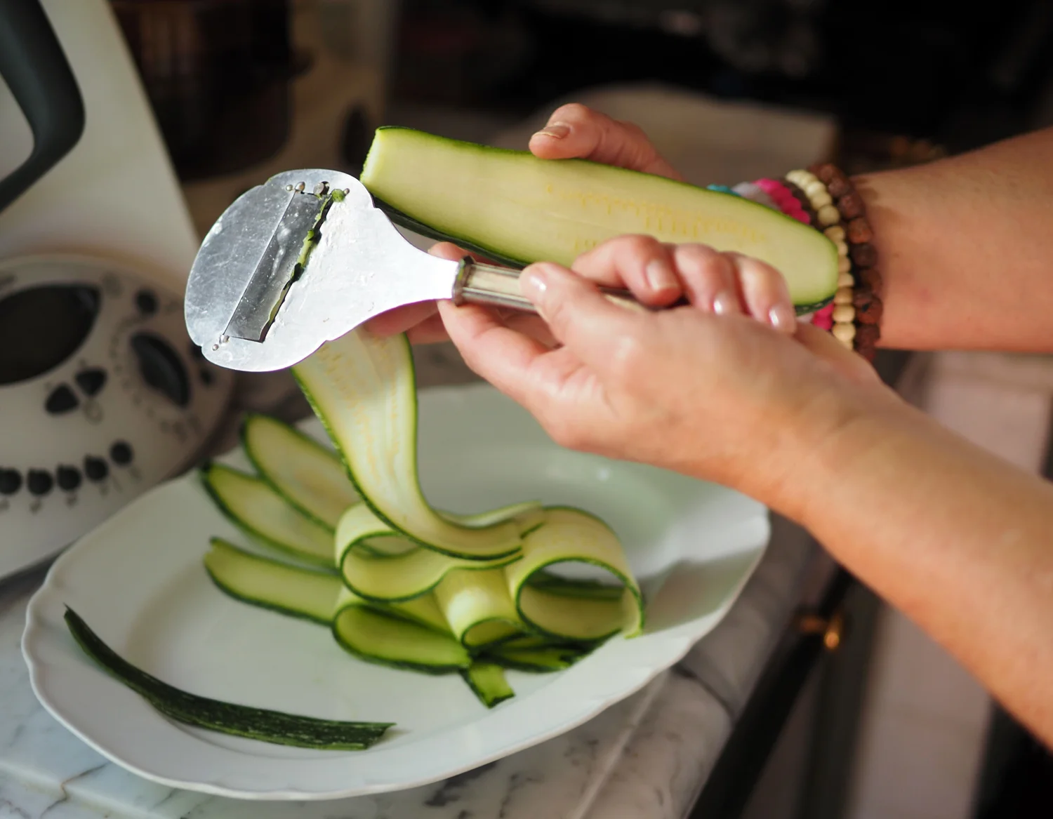 Shaving zucchini into ribbons of freshness.