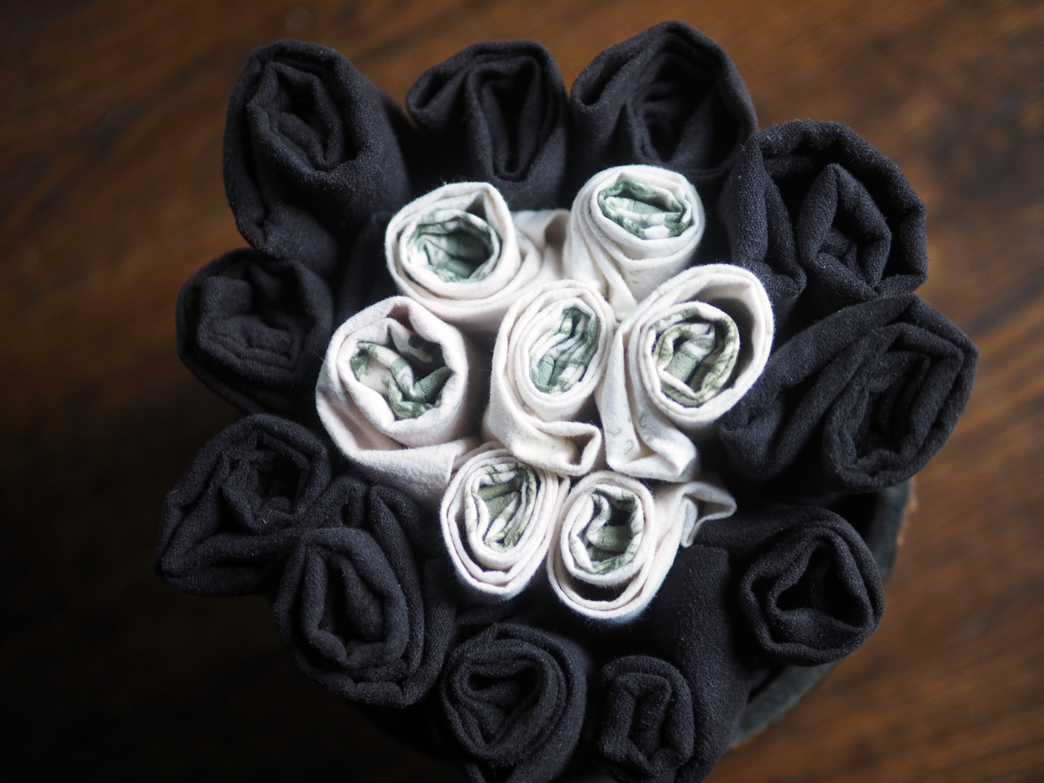 I didn't have enough black napkins so I used a cream/green one to coordinate. The way to make it look planned is to concentrate the colors. I choose to use the darker color for the circular perimeter with the light colored center. It feels like a flower.