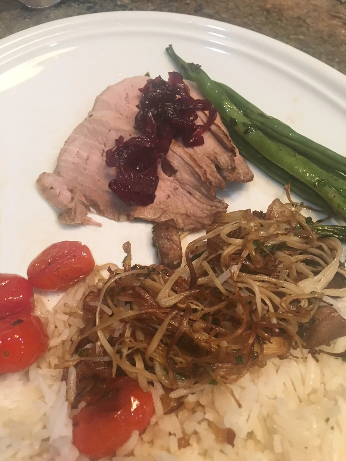 Pork loin, basmati rice with onions and Enoki mushrooms, Haricot verts and pan seared tomatoes.