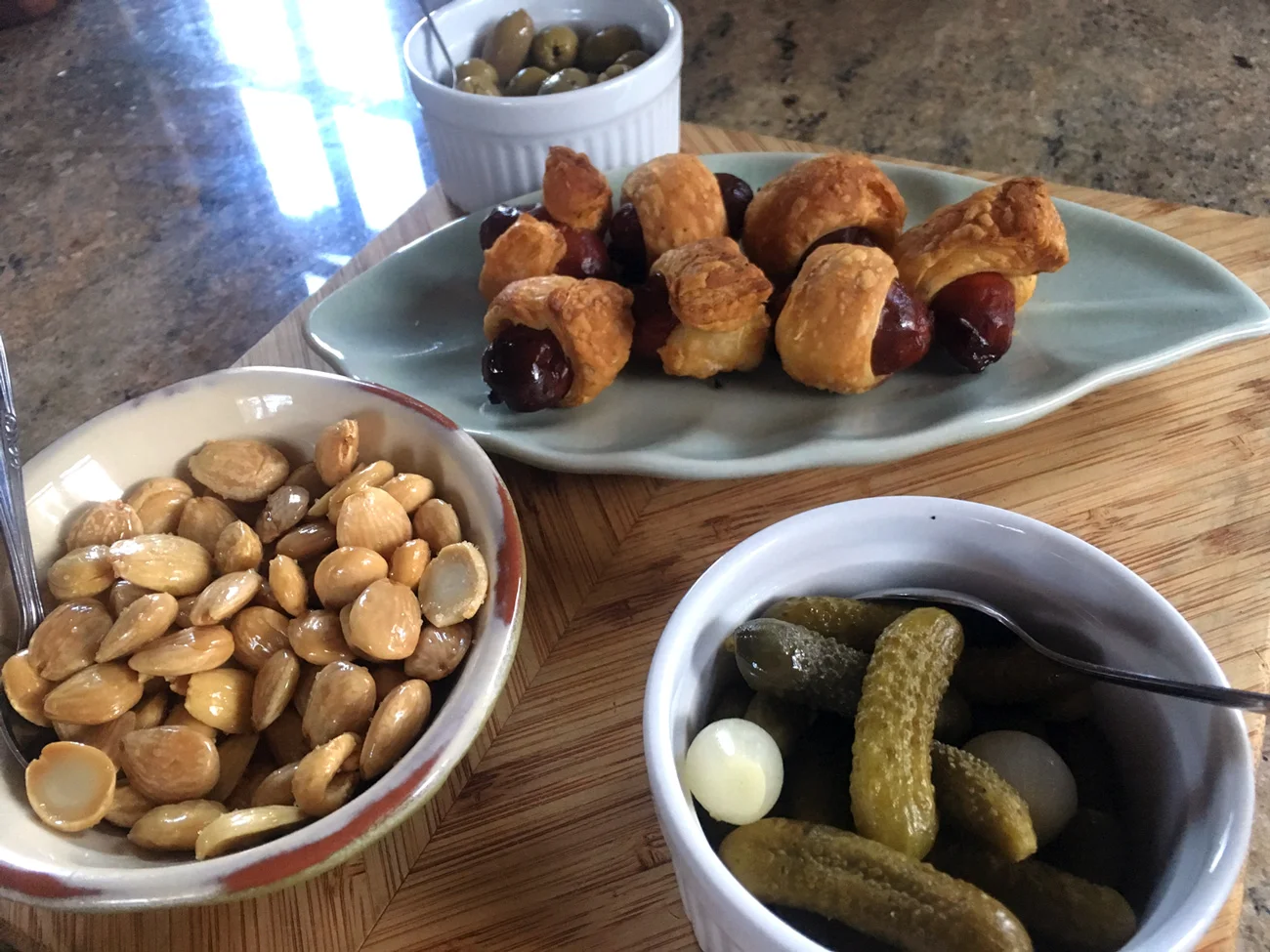 The puff pastry adds a buttery flavor that complements the spice of the chorizo. These are a more grown up way of serving Pigs in a Blanket. Adding a nod to France, I mixed up whole grain mustard with dijon for dipping. Marcona almonds and cornichons for crunchy, salty bites.