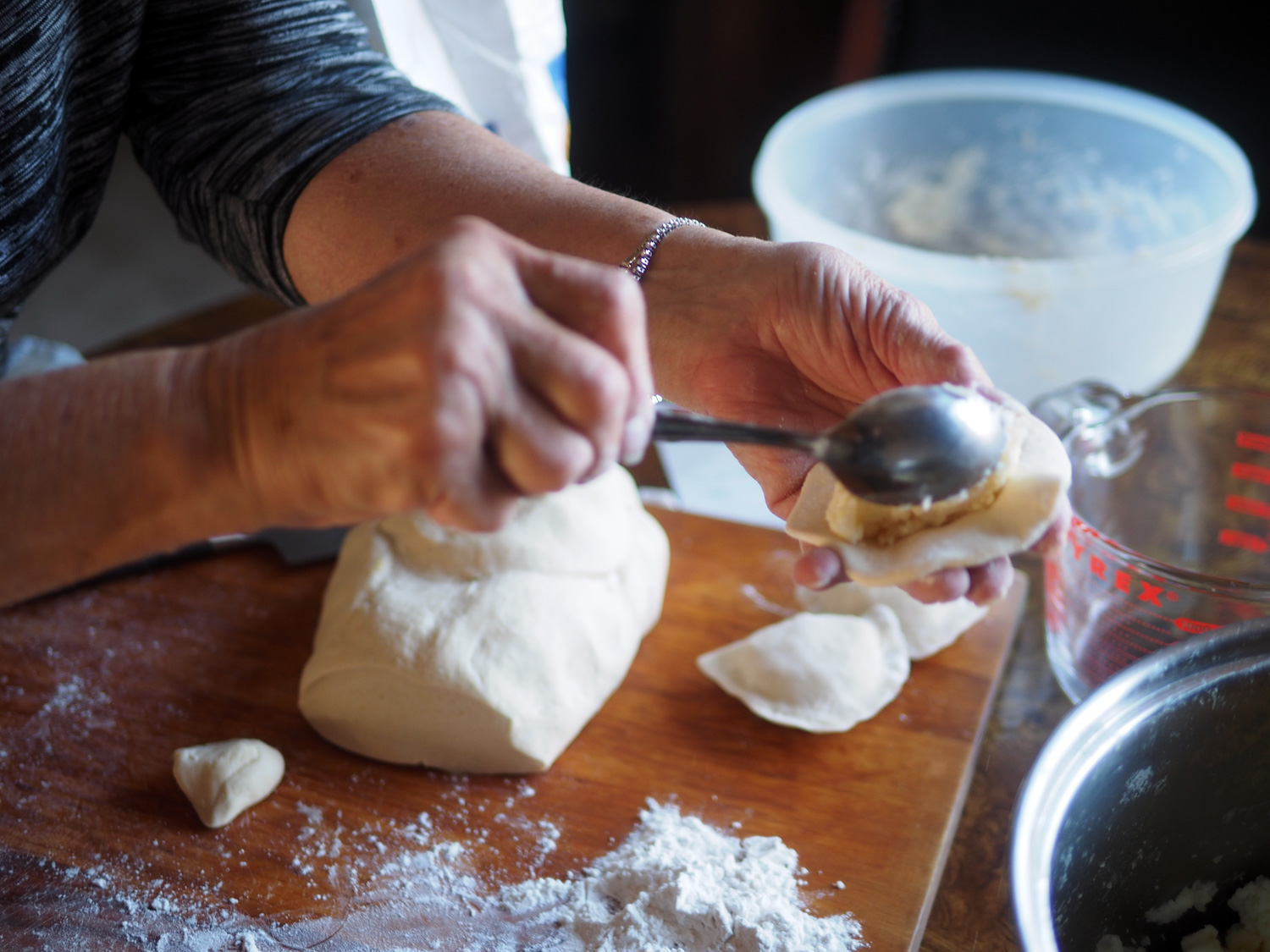 Place a heaping tablespoon in the center of the round. Take note of the small cut piece. That is the size before being rolled out.