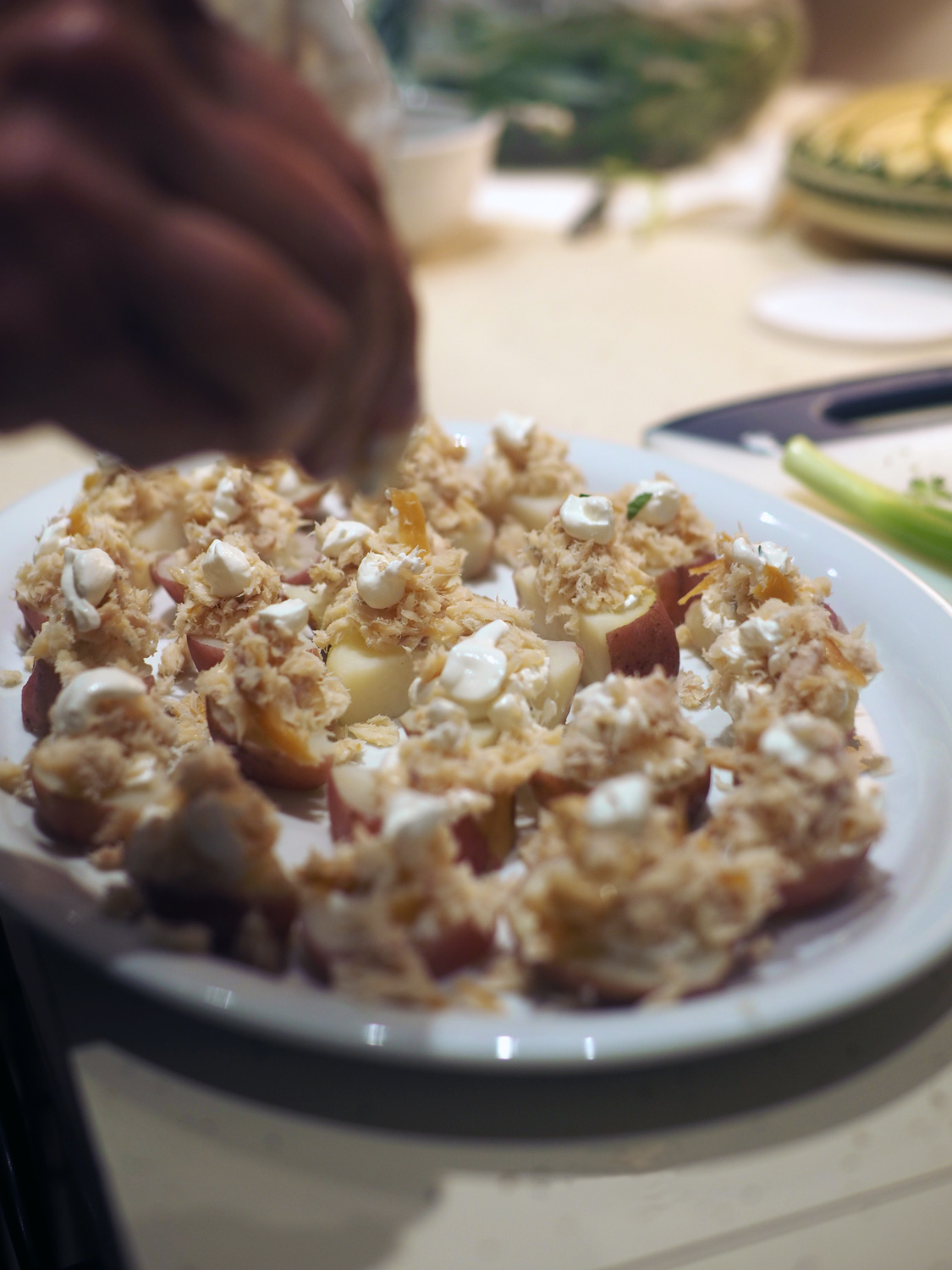 Making the potato topped with with smoked trout & sour cream
