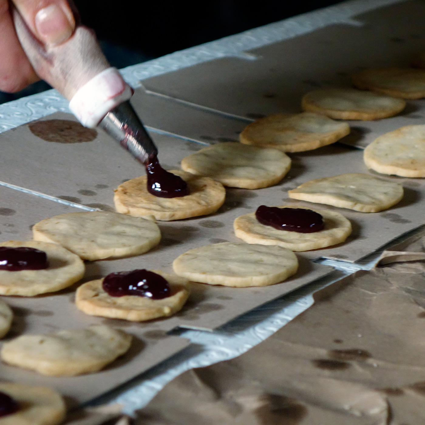 I always try to find the most efficient way to accomplish a task. Putting the jam in a piping bag or a plastic bag makes it easier to dollop onto each cookie. Photo credit: asithappens.format.com