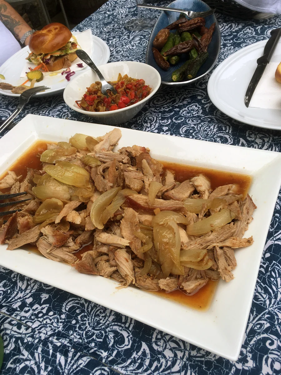 A platter full of pork with luscious juices and soft, flavorful onions.
