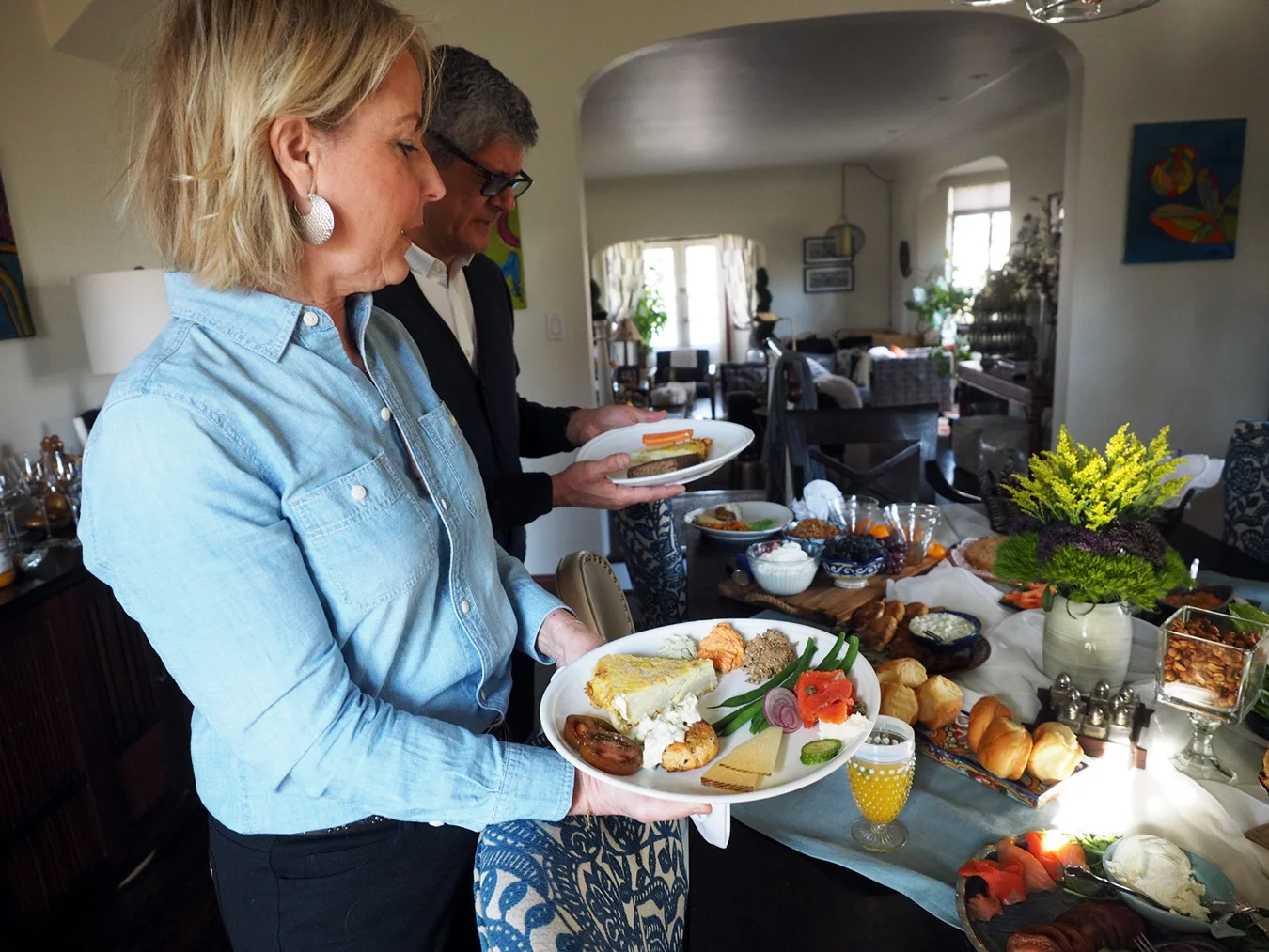 Bruce and Maryann eyeing the offerings and creating a sumptuous plate of good bites.