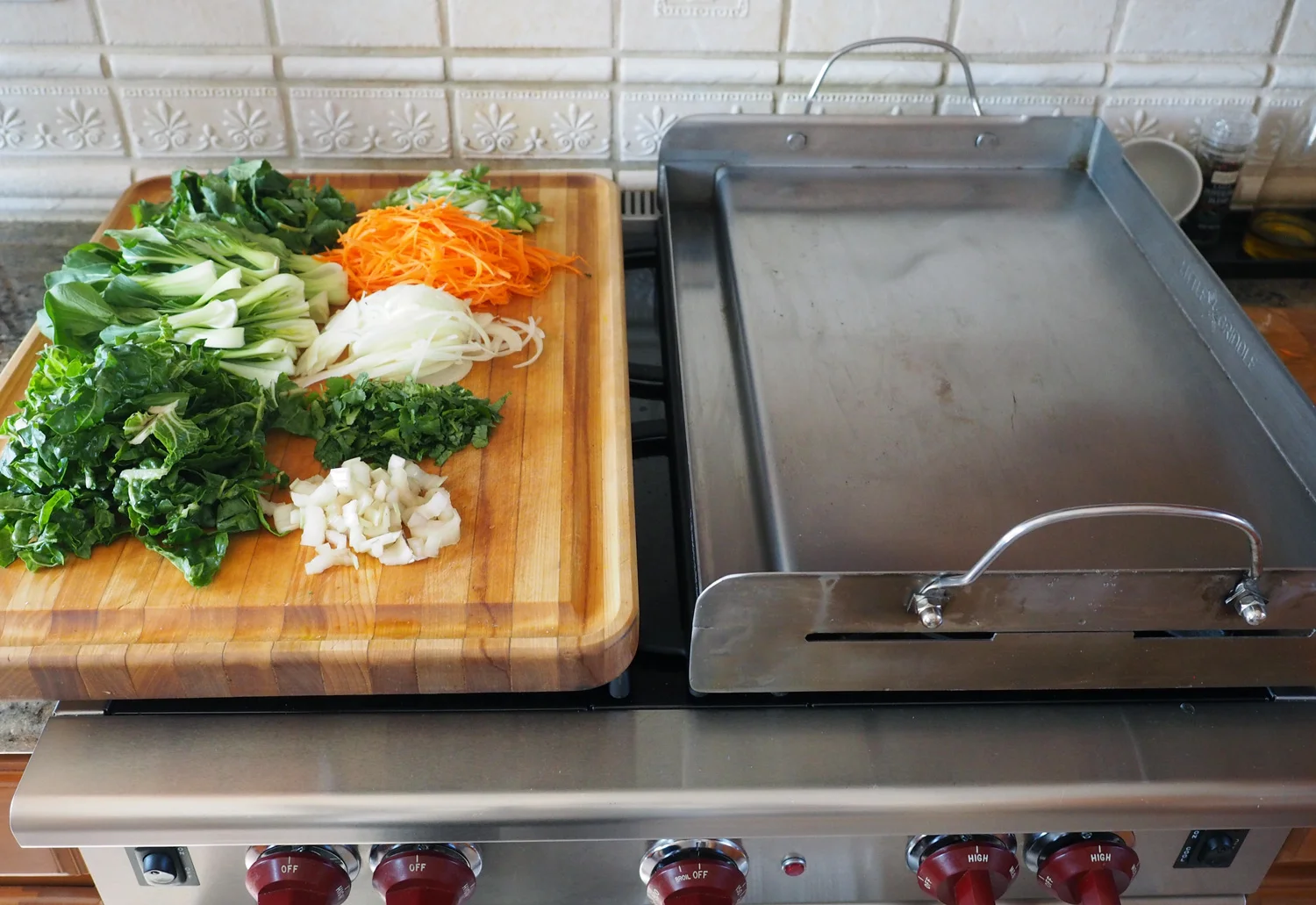 It fits perfectly over two burners. I love this plancha.