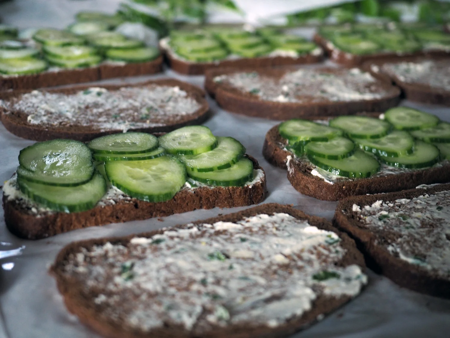 I placed 3 slices in a row x3. This way when I cut the bread into finger sandwiches I used the cucumber rows as my guide to create 3 bite sized sandwiches.