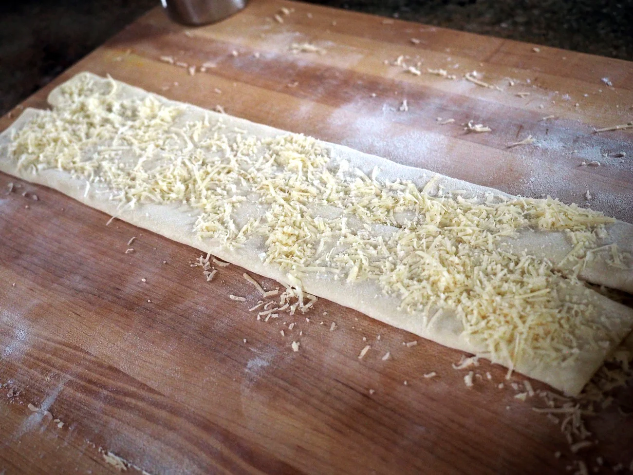 More cheese, please. This is the second fold. From this point, fold one more time to close it up.