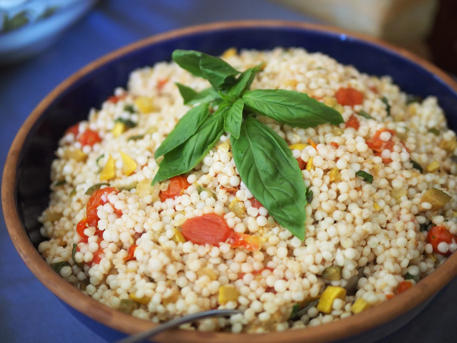 Israeli Couscous , it’s fluffy and light but satisfyingly filling. The oven roasted garlic and tomatoes give this dish it’s depth of flavor.