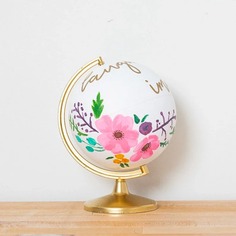 Globe that has been personalized with flowers on it