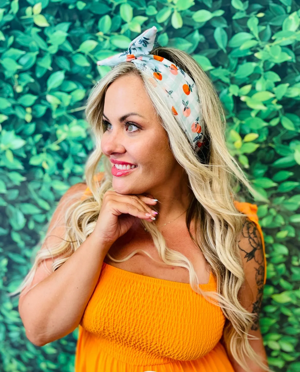 Woman with tie headband with oranges on in