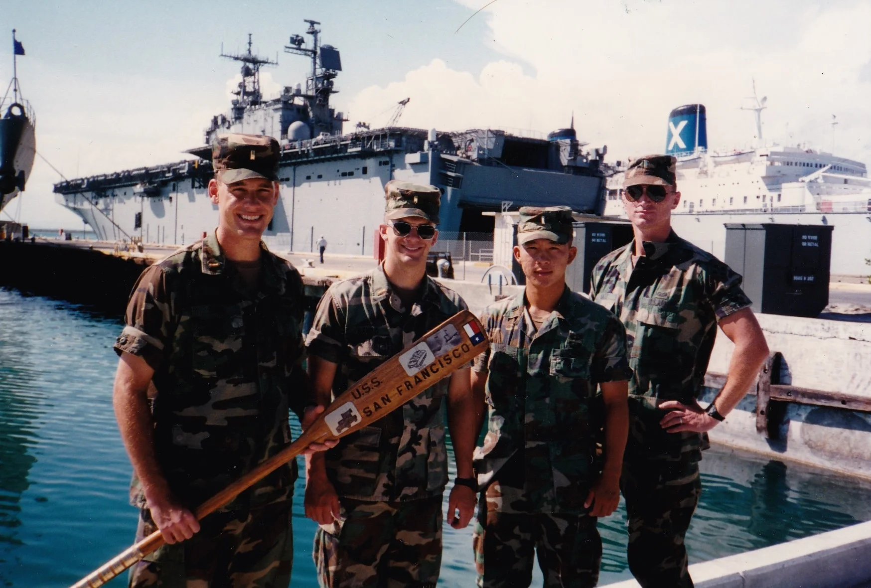 “CMO Kurt Kane (far left, holding oar) stands with fellow lieutenants from the 4th Infantry Division at Guantanamo Bay Naval Station. The oar he is holding was their unit symbol.”