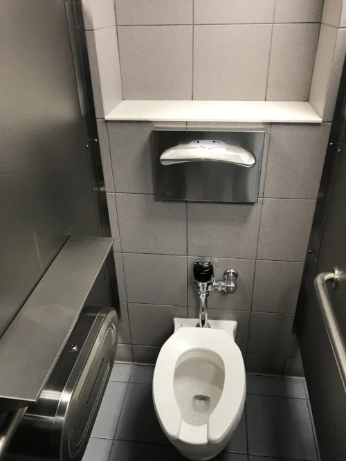 Typical stall in the E-gates; note the small shelf above the toilet for storage.