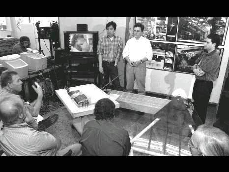 Figure 8: An MIT architectural design jury in which a remote juror (shown on the television screen) is participating through the aid of teleconferencing technologies.