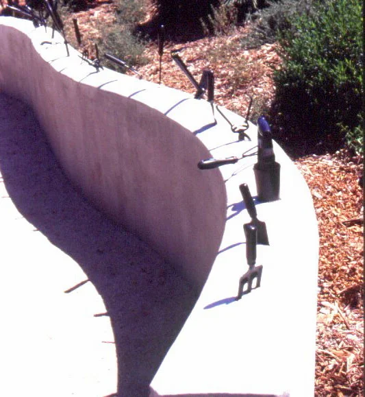 Figure 10: The Water Conservation Demonstration Garden in San Diego, California: Gardening tools fixed on top of a low wall.