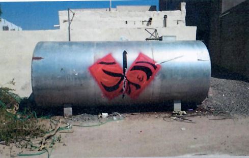  Images of the water tanks that participating artists covered in brightly-colored, abstract designs 