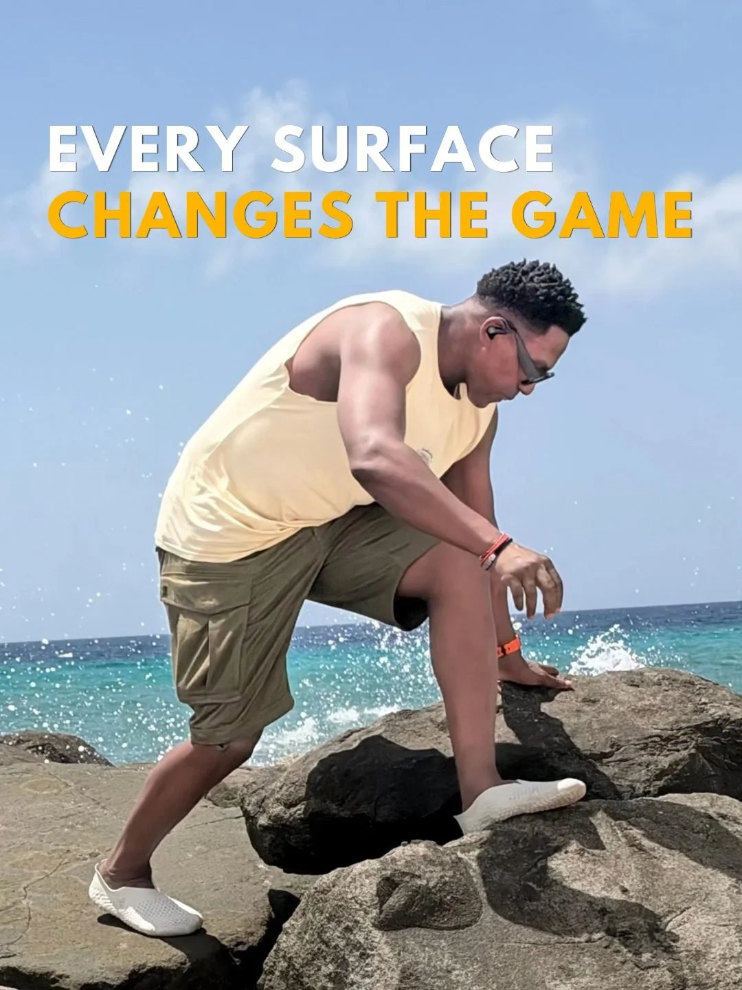Darryl Edwards steps across uneven rocks by the sea, exploring different ways to move.