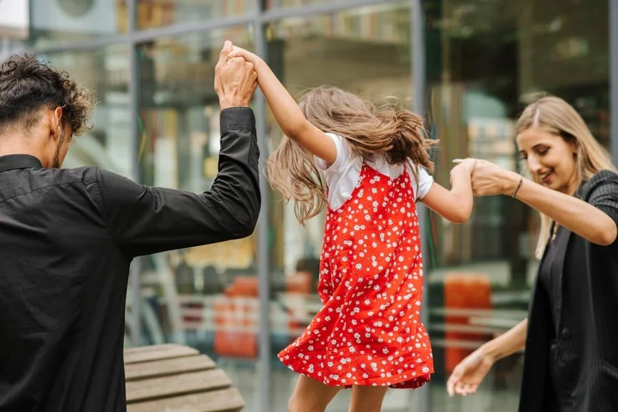 Family members playing together outdoors.