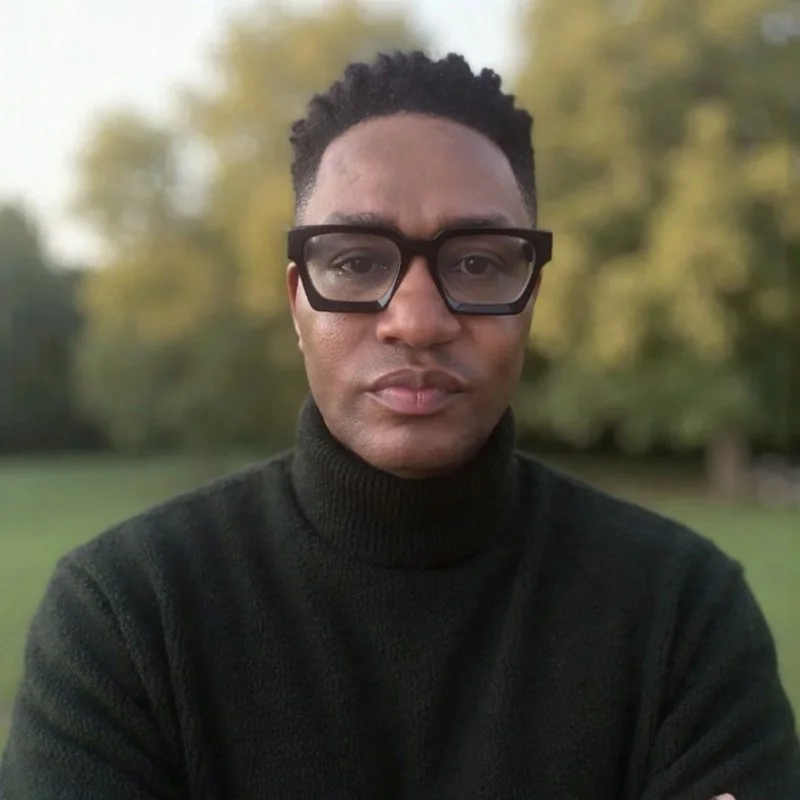 Headshot of Darryl Edwards, movement coach and exercise medicine specialist, looking directly at the camera against an outdoors background.